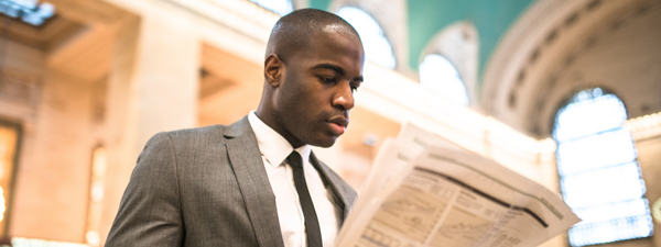 photo of a man reading a newspaper